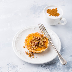 Pumpkin mini pie, tartlet made for Thanksgiving day on gray stone background. Healthy autumn food concept with copy space.