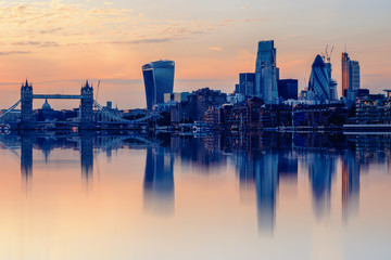 Cityscape of London at sunset with reflection from river Thames
