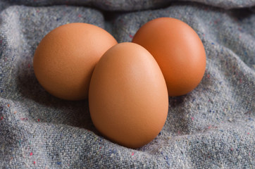 Close-up raw chicken eggs on fabric background