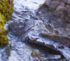 mountain trickle with ice after night frosts in autumn.