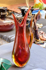 red curvy vintage vase on sale at street market, Chiavari , Italy