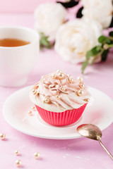 Pink cupcake decorated with pearl beads