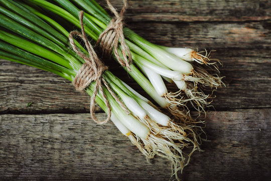 spring onion Isolated on wooden background