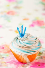 Blue cupcake in orange cup