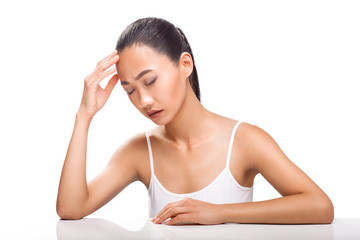 Young Asian woman having headache isolated on white background
