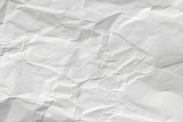 The texture of white paper with kinks. Background of a crumpled surface.