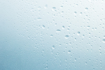 Light rain on the window glass, grainy texture on background