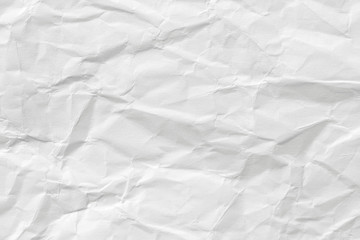 The texture of white paper with kinks. Background of a crumpled surface.