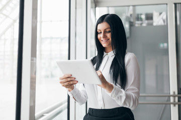 Successful confident business woman working with tablet in an office setting