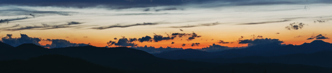 Sunset in the Carpathian Mountains. Silhouettes of the mountain range.