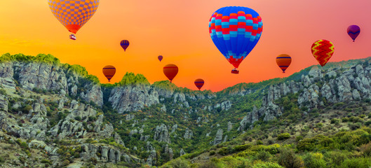 hot air balloons in sunrise landscape