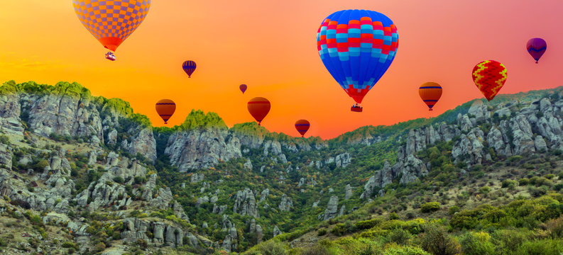 hot air balloons in sunrise landscape