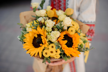 Ukrainian girl with a bouquet of yellow sunflowers