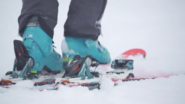 Skier clipping in and sliding away