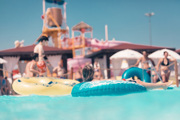 Young people having fun on the water slide with friends and familiy in the aqua fun park glides,...