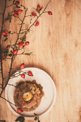 Still life with candle and dogrose branches
