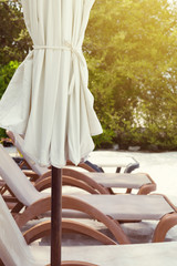 White parasol with sun chairs