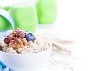 Delicious oatmeal porridge with berries and nuts