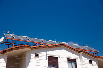 Contemporary hot water panels on a house, solar heater for green energy