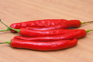 fresh red chilies on a wooden background