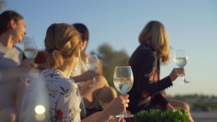 Four laughing girls have a wine party seaside sunrise rapid slow motion