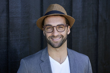 Fototapeta na wymiar Smiling guy in hat and glasses, portrait