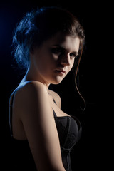 beautiful sad young woman on black background looking at camera