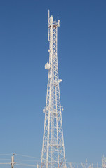 Telecom broadcasting tower network under blue sky