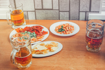 beer with snack on table