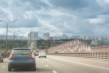 Highway interchange with bridge and clouds on the background