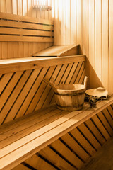 Fototapeta na wymiar wooden sauna cabin with sauna accessories, bucket, broom, oak scoop