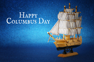 Columbus day concept with old ship glitter background