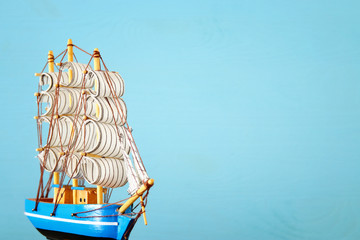 Columbus day concept with old ship over wooden background