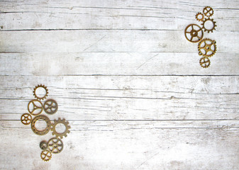 Gears on a wooden background, mechanical flat lay with copy space, steampunk style