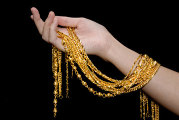 Gold neck lace ,Gold jewelry in woman's hands