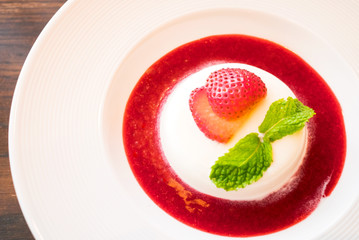 Panacotta with fresh strawberry and sauce on dish