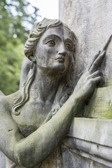 Obraz premium Statue of an angel woman in a cemetery.
