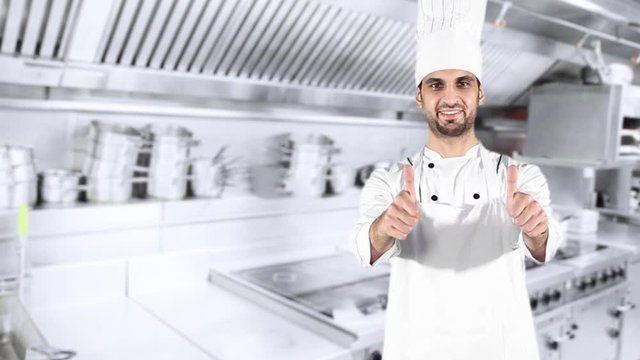 Male Caucasian chef showing two thumbs up in the kitchen room while smiling and wearing uniform