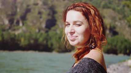 Portrait of young beautiful happy woman with red curly hair