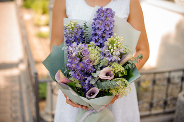 Lovely colorful wedding bouquet in woman hands