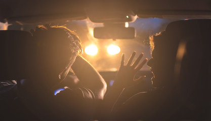 The man and woman drive a car in emergency situation. evening night time