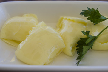 pat of fresh farm butter on a butter dish