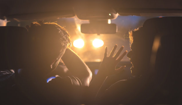 The Man And Woman Drive A Car In Emergency Situation. Evening Night Time