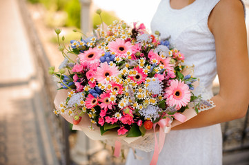 Colorful and pretty wedding bouquet in woman hands