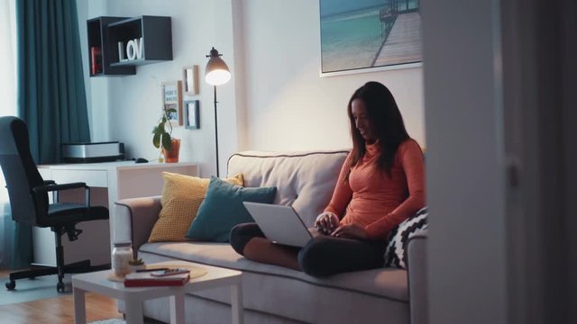 Young woman working on laptop at home