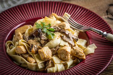Tagliatelle pasta with forest mushrooms and chicken.