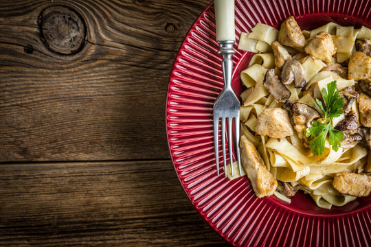 Tagliatelle pasta with forest mushrooms and chicken.