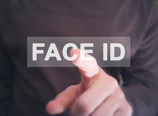 Businessman presses button face id.