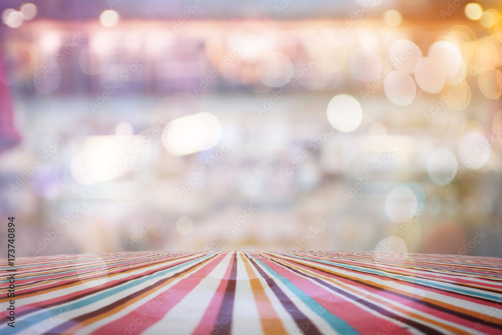 Aufkleber empty table with red polka dot tablecloth over abstract blur bokeh background