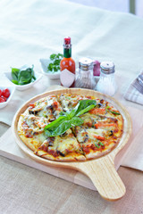 Homemade vegetable pizza on wooden plate cutting board style